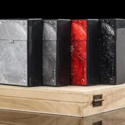 Plastic cigarette cases with embossed skull design, silver, black, red, and dark tones